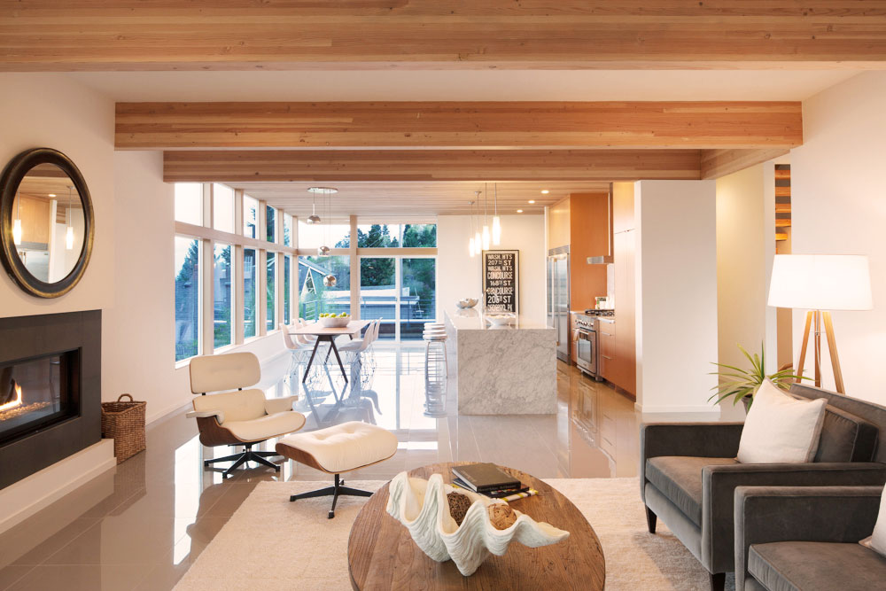Living room attached to kitchen with fireplace and mid century modern decor.