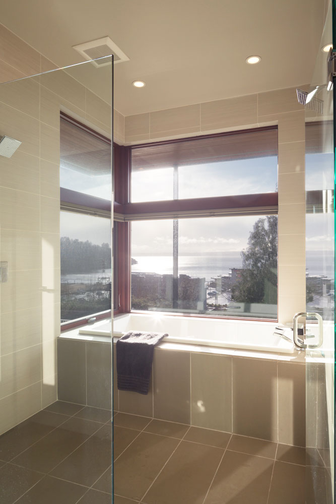 Bathroom with glass door to shower and bath tub.