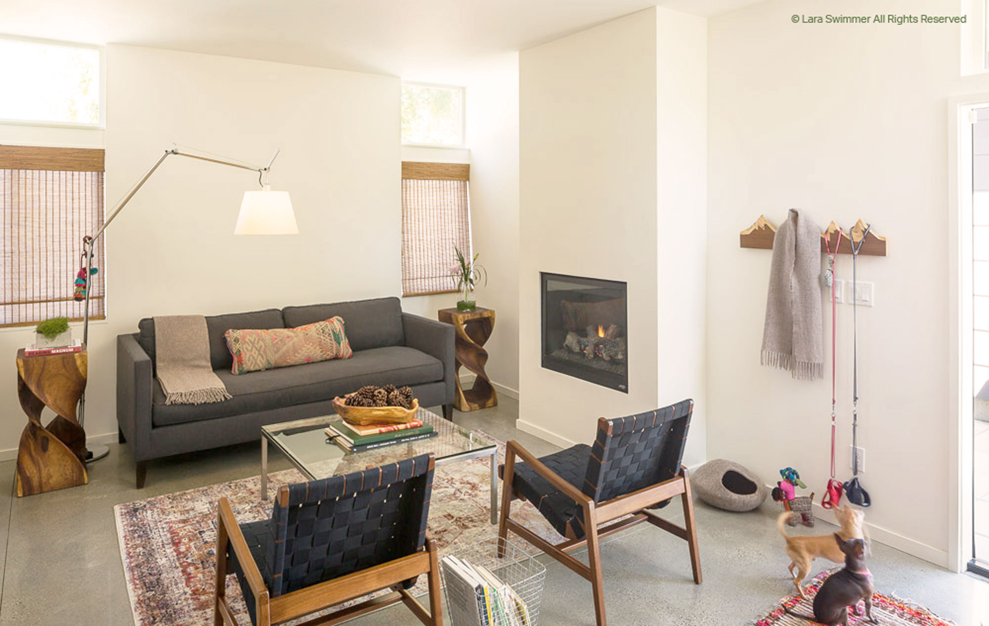 Living room with gray couch and chairs and a fireplace.