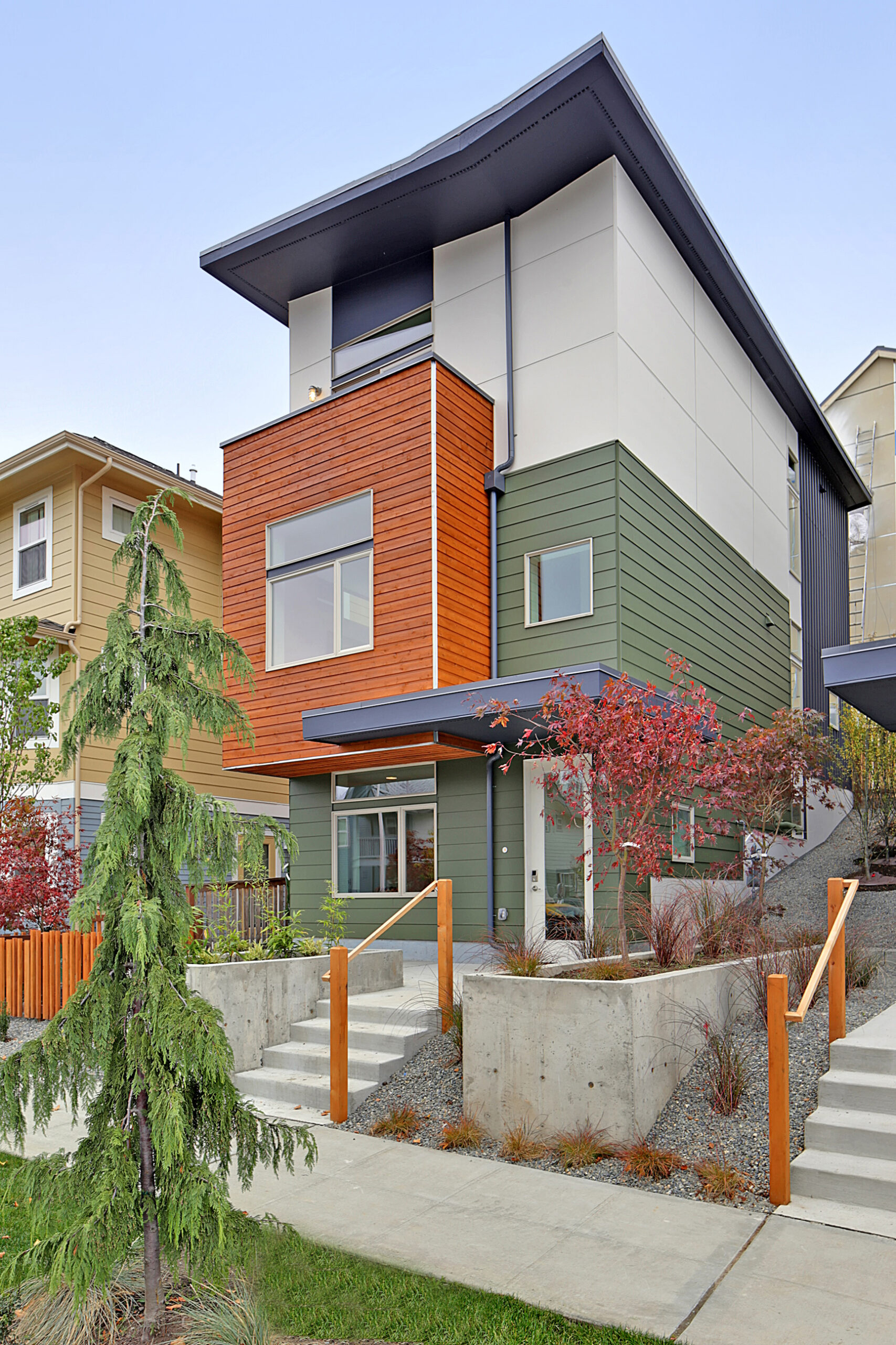 Exterior of one of the residences. This residence is white, orange, and olive green.