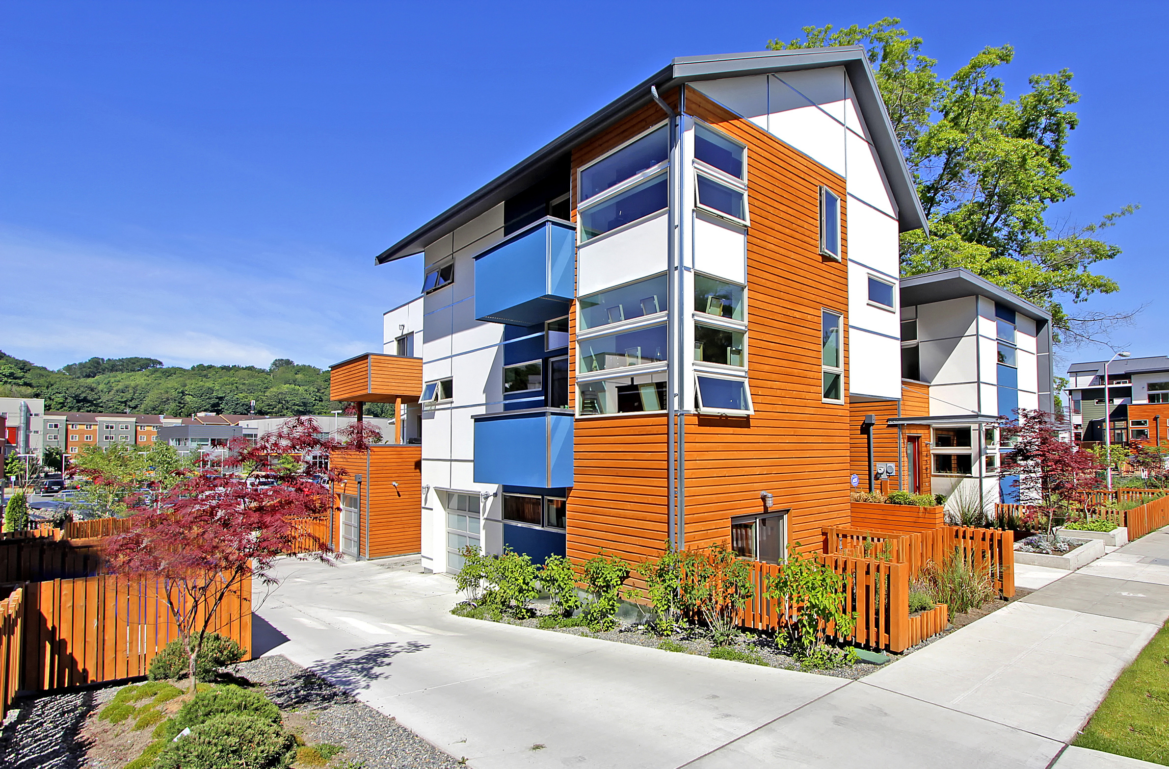 Exterior of one of the residences. This residence is white with medium wood.